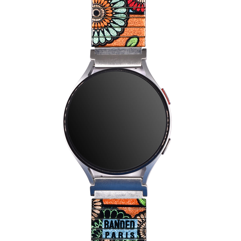 Flora Atomica - Jardin de Tulipes - Banded™️ for Smart Watch - Metallic Finish  Ein Strauß in Pariser Farben mit einem funkelnden Hintergrund in Orange. Eine Hommage an unseren Lieblingspark im Herzen von Paris, den Parc des Buttes-Chaumont.